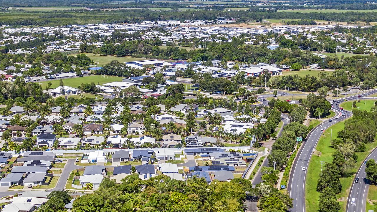 An aerial view of homes in Cairns with solar panels.