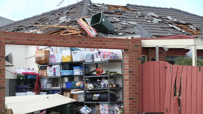 A wheelie bin on the damaged roof of a Oakwood Crescent home in Waurn Ponds. Picture: David Crosling