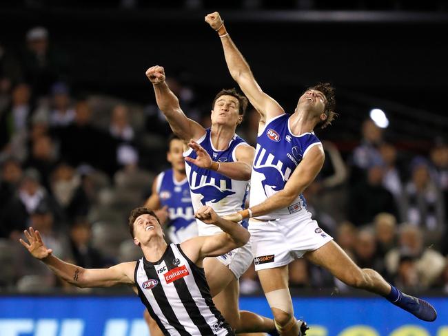 Brody Mihocek of the Magpies (left) and Scott Thompson and Luke McDonald of the Kangaroos compete for the ball during the Kangaroos’ 44-point win. Picture: Michael Willson/AFL Photos via Getty Images