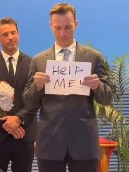 He pulled out a sign saying "help me". Picture: TikTok