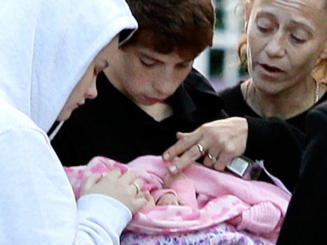 Jenifer Morrison, 15 and her boyfriend Jayden Lavender, 14, holding baby Aria, and Jayden’s mother Tracy Lavender, after the young couple had spent a night on the run with their newborn. Picture: Justin Sanson