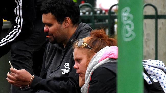 A man gets a needle ready after a suspected drug deal on Victoria St, Richmond. Picture: Nicole Garmston