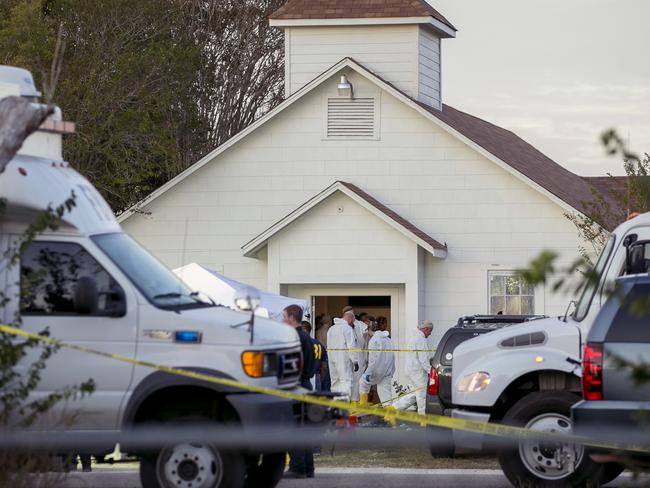 Investigators work at the scene of the mass shooting. Picture:AP