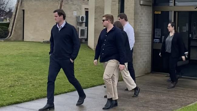 James Bryson, at rear in white shirt, leaving court with supporters after he pleaded guilty to two counts of causing death by dangerous driving. Picture: Jessica Dempster