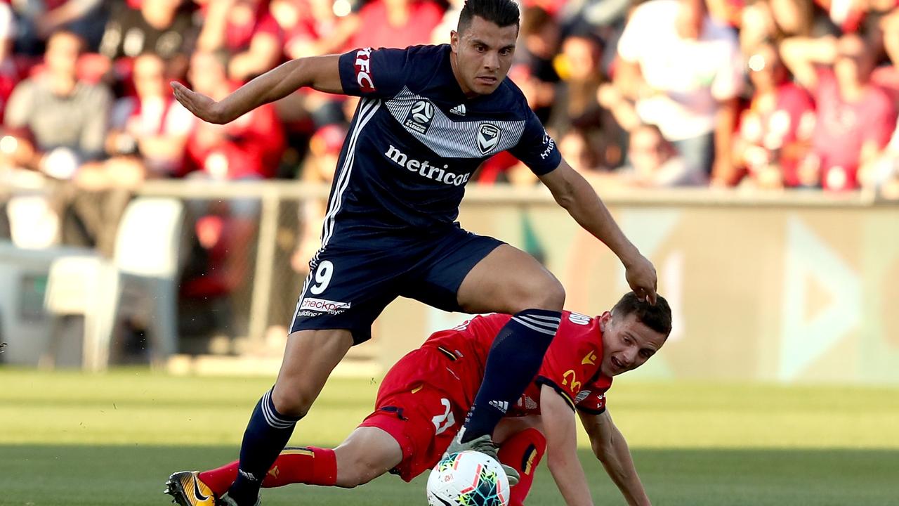 Andrew Nabbout snatches possession from Adelaide United’s Louis D'Arrigo.