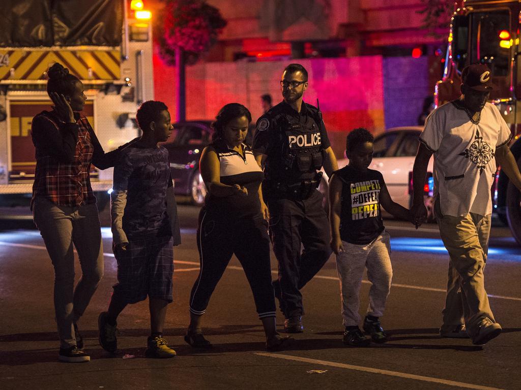 Police escort civilians away from the scene of a shooting in Toronto. Picture: AP