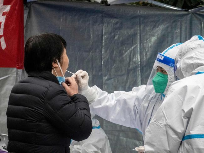 A resident undergoes a nucleic acid test for Covid-19 in Xi'an in China's northern Shaanxi province. Picture: AFP / China OUT