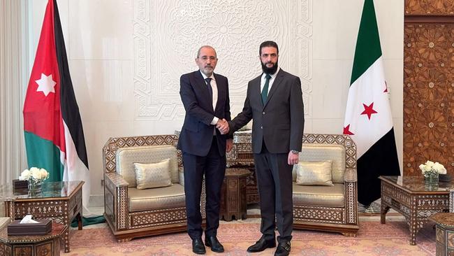 Jordan's Foreign Minister Ayman Safadi is received by HTS leader Ahmed al-Sharaa in Damascus on December 23. Picture: AFP Photo/Jordanian Foreign Ministry