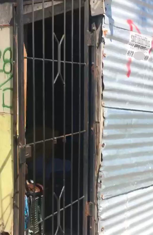 A poster advertises "pain free abortion" outside a shack in the Langa township of South Africa. Picture: Megan Palin.