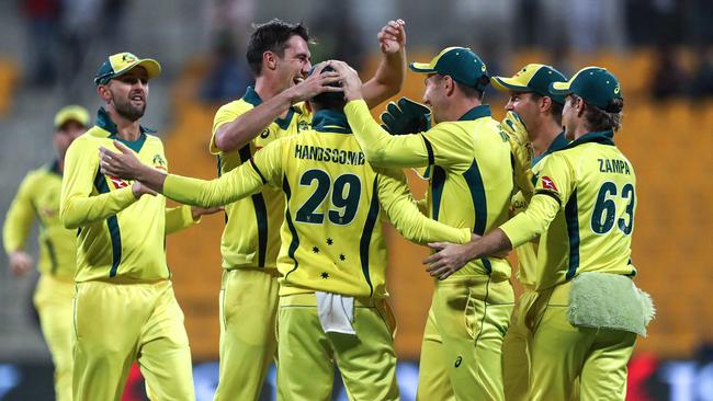 Australian fast bowler Pat Cummins celebrates with teammates after snaring the wicket of Pakistan’s Shan Masood. Picture: AFP