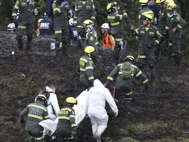 Rescue workers retrieve the body of one of the 76 victims, in the mountains near Medellin in Colombia.