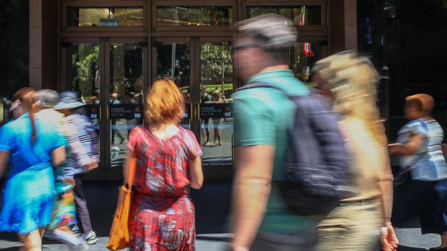 SYDNEY, AUSTRALIA - DECEMBER 24: People walk in the front of the David Jones flagship store on Elizabeth Street on December 24, 2024 in Sydney, Australia. The Australian economy is experiencing subdued growth, with GDP increasing by only 0.2% in the second quarter of 2024, largely due to declining consumer spending and high interest rates. Household consumption has dropped, reflecting ongoing cost-of-living pressures, as consumers prioritize necessities over discretionary spending. (Photo by Roni Bintang/Getty Images)