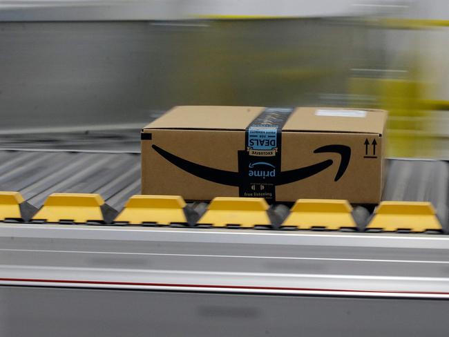FILE- In this Feb. 9, 2018, file photo, a box for an Amazon prime customer moves through the new Amazon Fulfillment Center in Sacramento, Calif. President Donald Trump took another shot at Amazon.com on Thursday, March 29, tweeting that the online retailer pays â€œlittle or no taxesâ€ and that it uses the U.S. Post Service as a â€œDelivery Boy.â€ (AP Photo/Rich Pedroncelli)