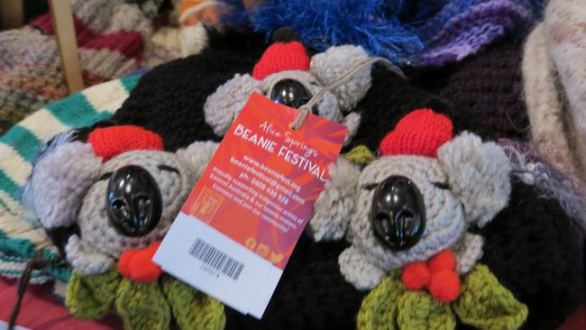 Dozens of volunteers are busy hanging thousands of beanies in preparation for the 28th Alice Springs Beanie Festival. Picture: Gera Kazakov