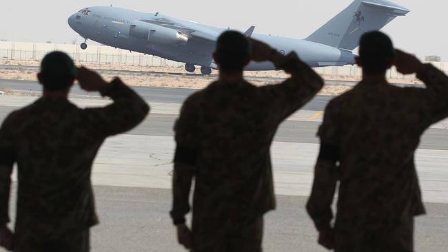 Australian Special Forces soldiers say a final farewell as they salute their fallen mates, as their sad journey home begins. Picture: Supplied