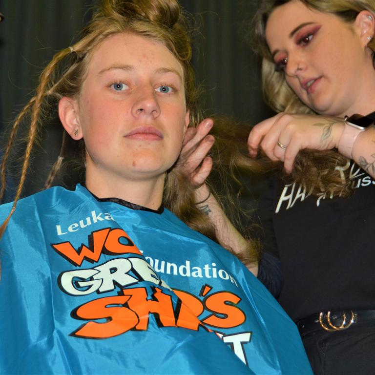 At the St Joseph's College 2023 World's Greatest Shave event is student Emily Chandler getting her hair cut by her support crew and hairdresser Natalie Schmidt from the Hair Room on Russell. Picture: Rhylea Millar