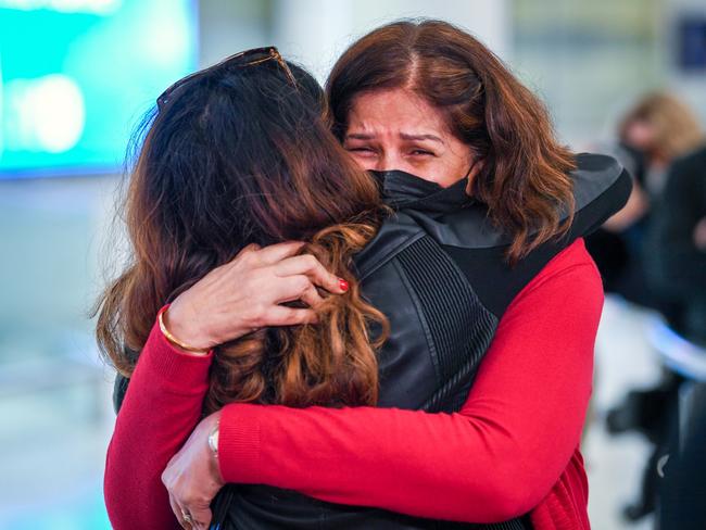 Passengers greet family members after landing from Singapore on November 21. Picture: James D. Morgan/Getty Images for Tourism Australia