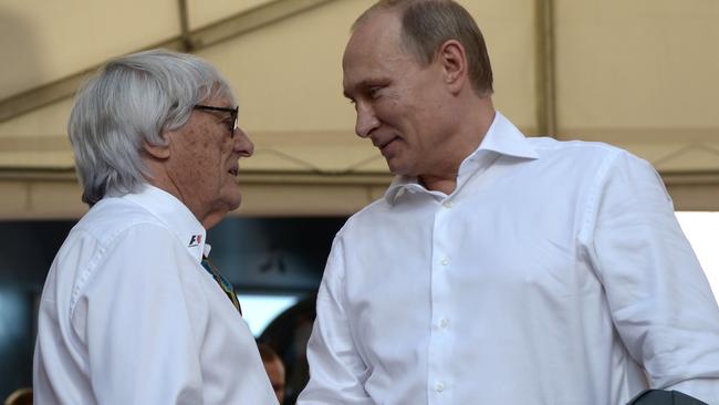 Is Russian President Vladimir Putin, pictured here with Formula One chief executive Bernie Ecclestone, getting some practice in, in his shirt-front. Picture: AP Photo/RIA-Novosti, Alexei Nikolsky, Presidential Press Service