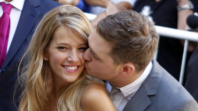 Canadian pop star Michael Buble kisses his bride Argentine TV actress Luisana Lopilato after their brief civil wedding in Buenos Aires, Argentina, March 31, 2011. (AP Photo/Natacha Pisarenko)