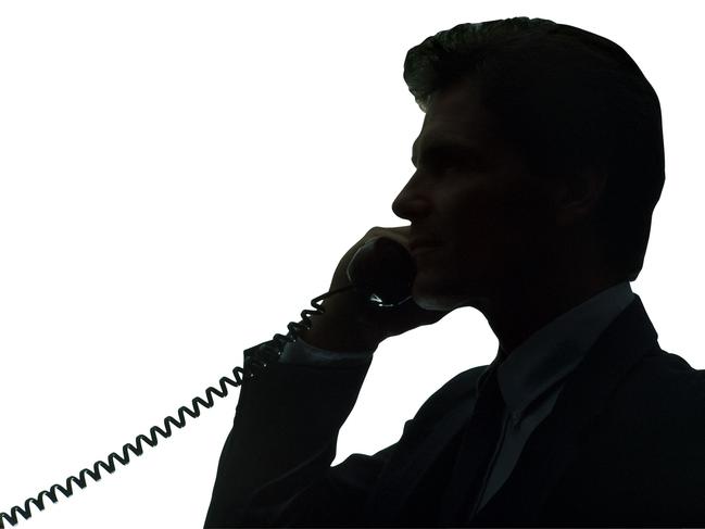 Silhouette of businessman talking on telephone.