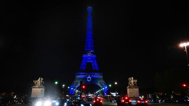 The Eiffel Tower illuminated with the Star of David and the national flag of Israel.