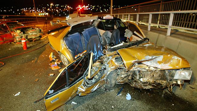 The severely damaged gold Gemini and Fenton’s red Commodore after the crash.