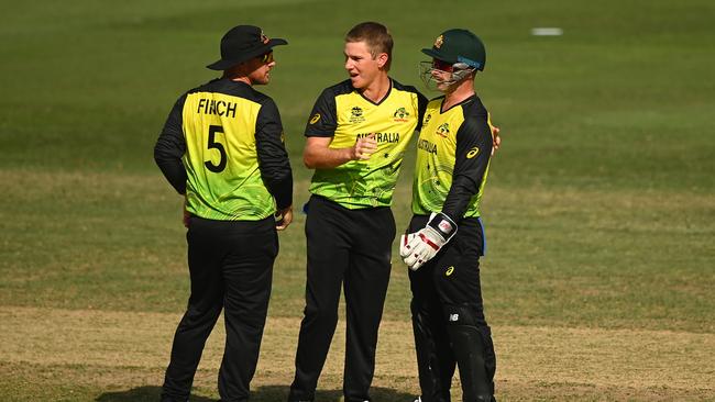 Adam Zampa, centre, celebrates the wicket of Afif Hossain with captain Aaron Finch, left, and keeper Matthew Wade Picture: Getty Images