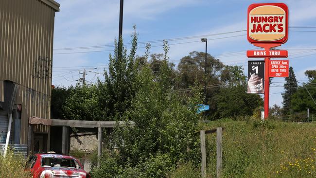 Squatters are living under the Ringwood Gateway Bridge, among heaps of stuff dumped in a house next to Hungry Jacks. Picture: Stuart Milligan