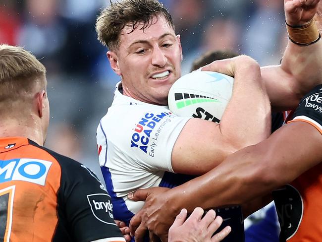 SYDNEY, AUSTRALIA - JUNE 19:  Max King of the Bulldogs is tackled during the round 15 NRL match between the Canterbury Bulldogs and the Wests Tigers at CommBank Stadium, on June 19, 2022, in Sydney, Australia. (Photo by Matt King/Getty Images)