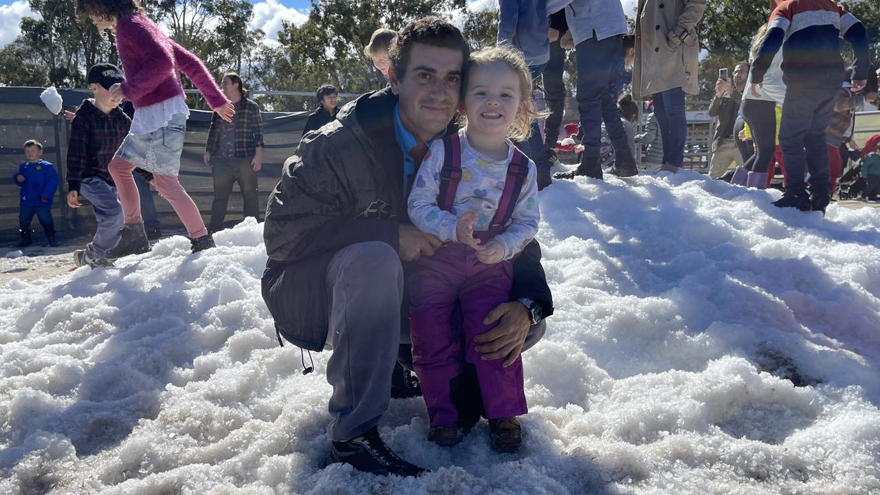 Father and daughter from Toowoomba Sean and Bella McGrath (2) frolic in the icy magic at the Snowflakes in Stanthorpe 2021 festival. Photo: Madison Mifsud-Ure / Stanthorpe Border Post