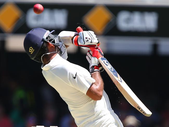 India's Cheteshwar Pujara “gloves” a ball from Australia's Josh Hazelwood to be dismissed for 18.