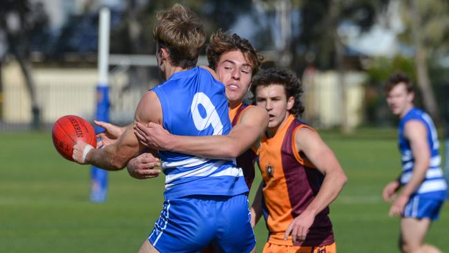 St Michael’s star Adam D’Aloia tackles James Higgins from St Peters as Will Shepherd waits for the ball during a match last year. Picture: Brenton Edwards