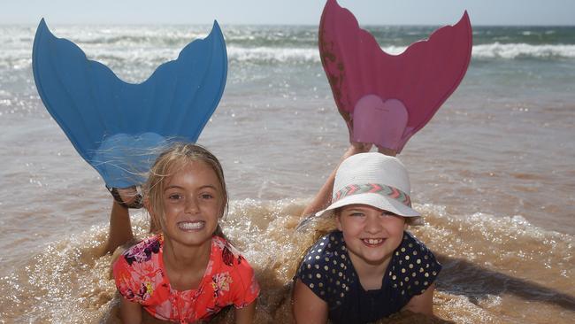 Amelie Shelley 8 and Matilda Baxter savouring the cool waves at Dee Why Picture: Martin Lange