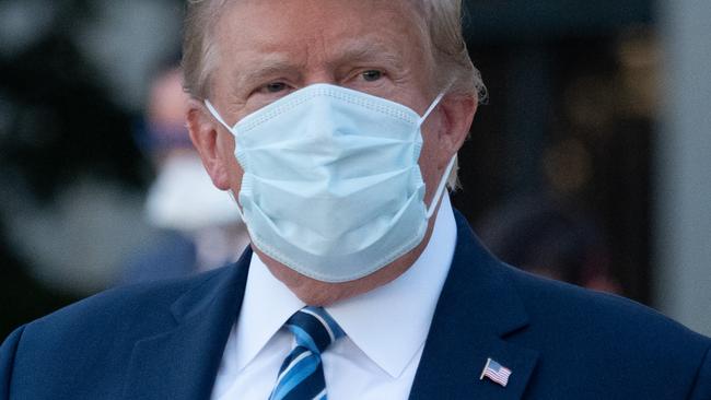 Then US president Donald Trump leaves hospital last October after being discharged following treatment for Covid infection, before the vaccinations rush began. Picture: AFP