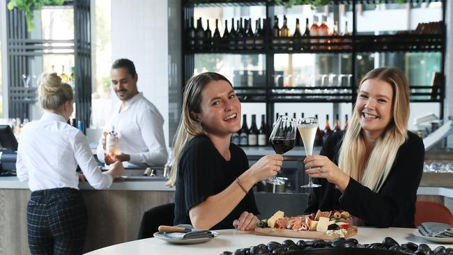 Crystalbrook Bailey boutique wine bar, Arte’s, food and beverage manager Tiago Teixeira serves organic wine to Laura Clark, while Jamie Binder and Jodie Walsh enjoy a drink and a charcuterie board together. Picture: Brendan Radke