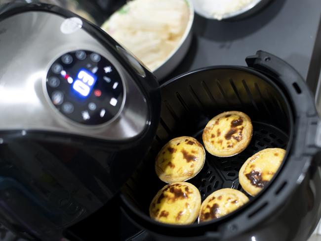 Air fryer machine in home, Egg Tart ( selective focus )