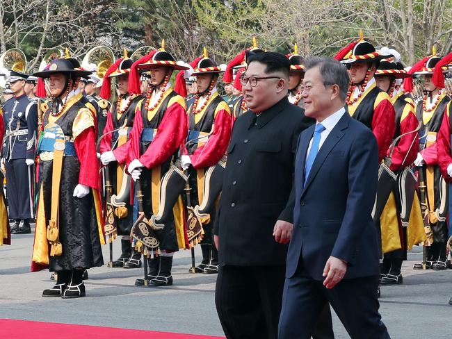 North Korea's leader Kim Jong Un walks with South Korea's President Moon Jae-in after meeting at the Military Demarcation Line that divides their countries. Picture: AFP