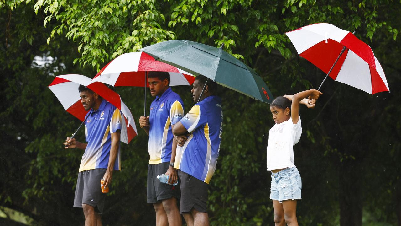 With Tropical Cyclone Megan threatening the Northern Territory and Queensland border, wet weather is forecast for Cairns this week. Spectators shelter from the heavy rain under umbrellas as they watch the A Grade match between the Cairns Kangaroos and the Innisfail Brothers at Vico Oval, Mooroobool. Picture: Brendan Radke