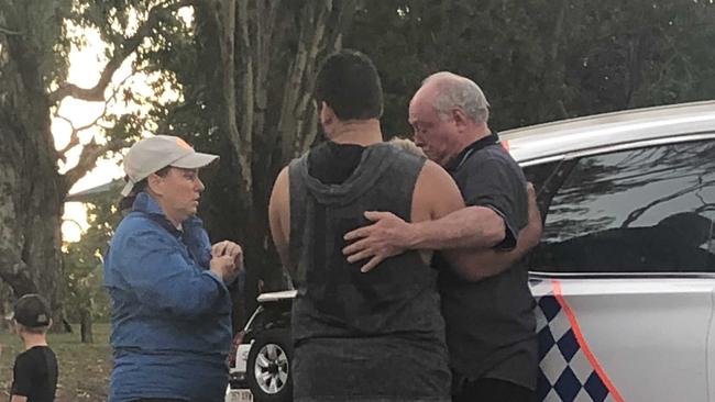 Distressed onlookers comfort each other as paramedics attempt to retrieve 10 people involved in a boat crash on the Fitzroy River.