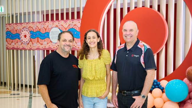 Target Group chief people and capability officer Tristram Gray, Indigenous Design Lab student Samara Francis and Indigenous Design Lab founder Leigh Harris unveil Target's new Deadly Store Network uniforms in Cairns on Tuesday. Photo: Supplied.