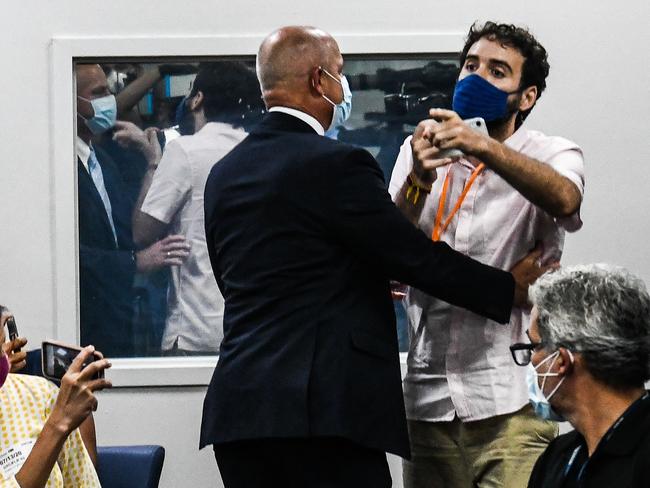 A man is escorted away by security as he interrupts the governor of Florida during a press conference. Picture: AFP