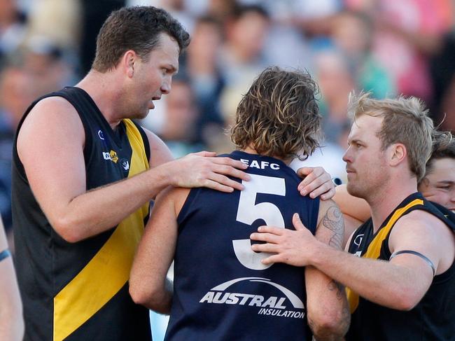 Seaford's Daniel Clarke (left) and Chris Fortnam (right) console Edithvale-Aspendale coach and former Frankston VFL teammate John Hynes after the 2009 MPNFL grand final. Fortnam is playing superules with the Frankston Tigersharks this season.