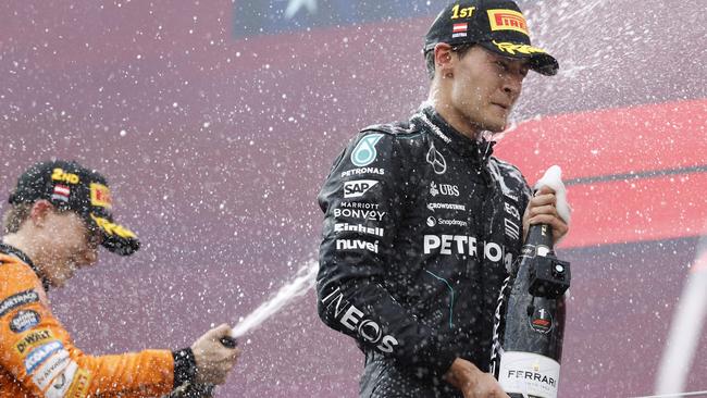 George Russell and Oscar Piastri celebrate on the podium after the Formula One Austrian Grand Prix. Picture: AFP