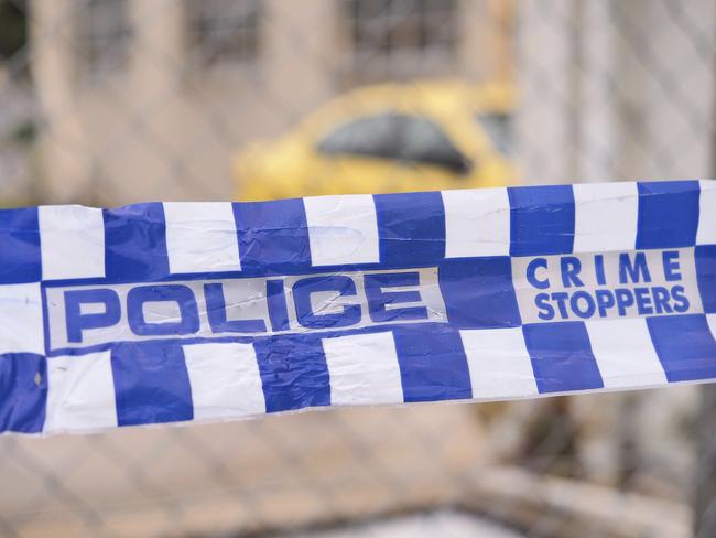 Blue and white Police tape cordoning off a area with a yellow car at a industrial area, Australia 2016Police tape cordoning off a area with a yellow car - Stock image  ipad generic