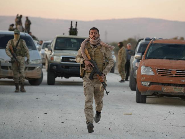 Anti-government fighters reach the highway near the the northern Syrian town of Azaz on December 1, 2024. The United States and its allies France, Germany and Britain called Sunday for "de-escalation" in Syria and urged in a joint statement for the protection of civilians and infrastructure. (Photo by Rami al SAYED / AFP)