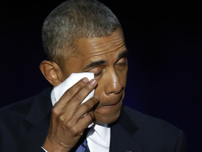 President Barack Obama wipes his tears as he acknowledges his wife, Michelle. Picture: AP