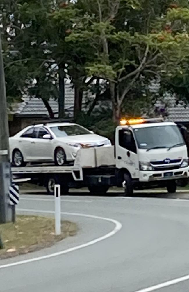 A white Toyota Camry being loaded up onto a tow truck after a motorcyclist collided with it late on June 28. Photo: Elizabeth Neil