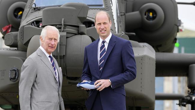 King Charles III officially handed over the role of Colonel-in-Chief of the Army Air Corps to Prince William in front of an Apache helicopter at the Army Aviation Centre in Hampshire on Monday. Picture: Getty Images