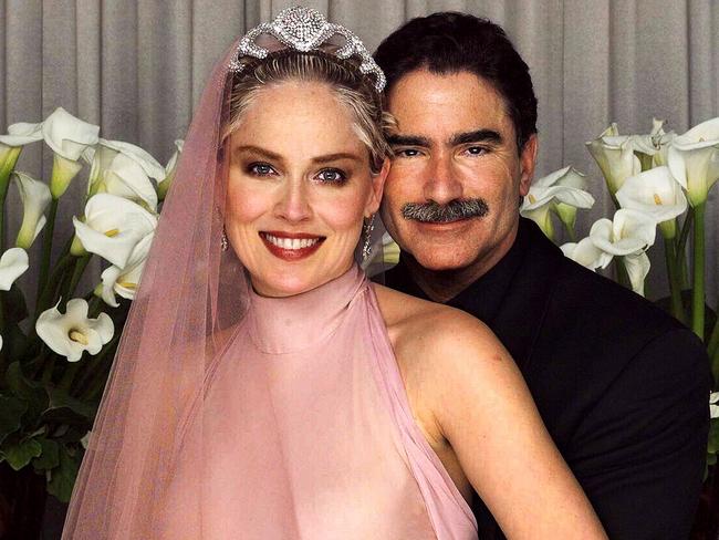 Sharon Stone in bridal gown posing with husband newspaper editor Phil Bronstein after secret wedding ceremony in 1998. Picture: Supplied