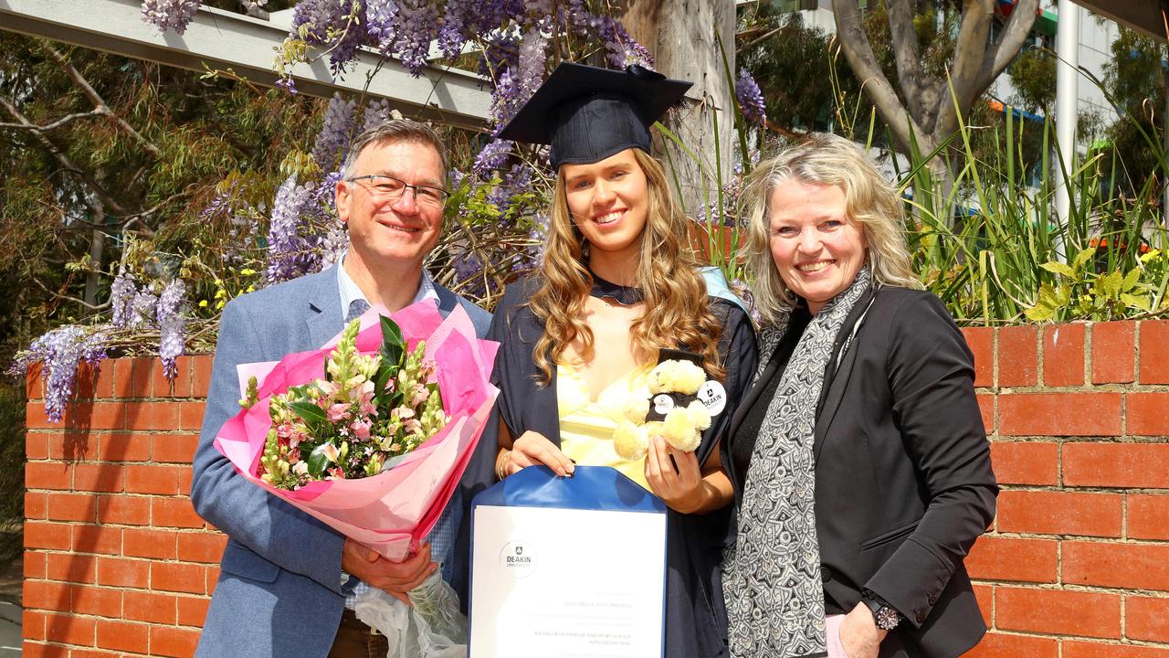 Deakin University graduate Annabelle Brown with parents Steven and Monique. Picture: Alison Wynd